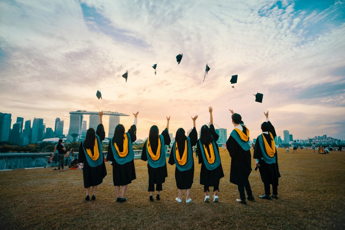 F-1 OPT STEM extension 2026 — African graduate at a US university ceremony