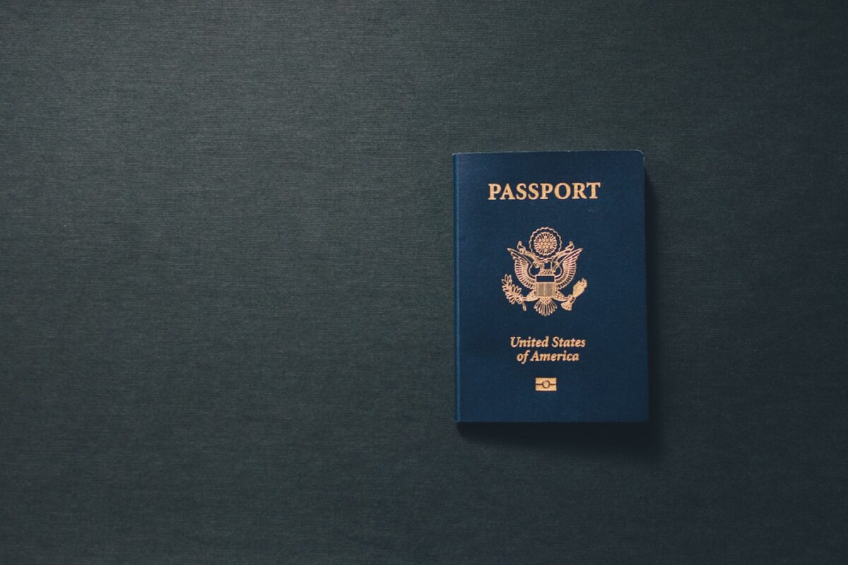 USCIS adjustment of status 2026 — passport and US flag