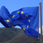 European Union flag outside an institutional building, symbolising the EU AI Act transparency rules now in force