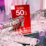 Retail clothing racks as Lululemon cuts full-year forecast for the second time in 2026