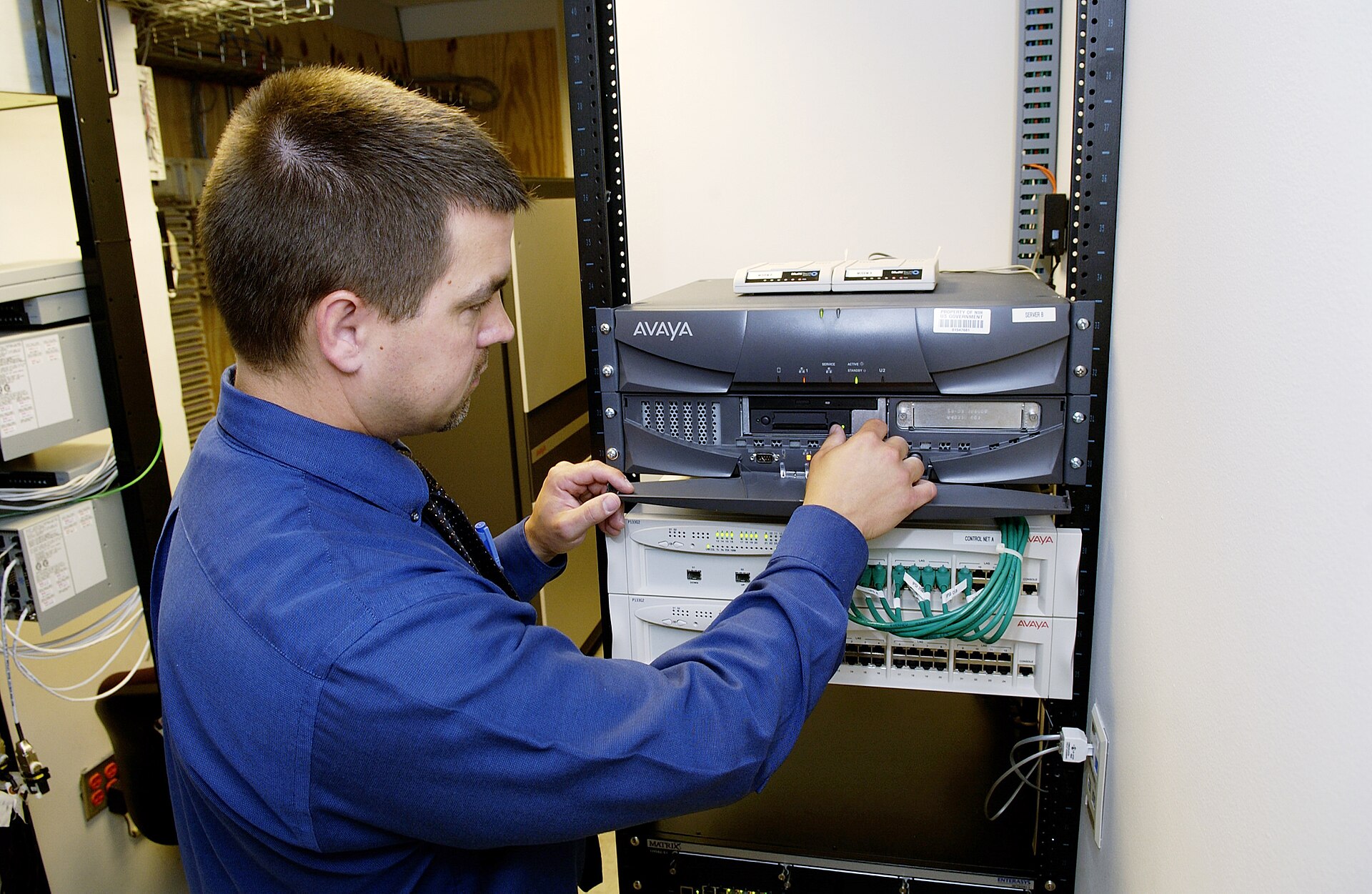 Technician working on servers of the kind governed by the Microsoft AI code of conduct