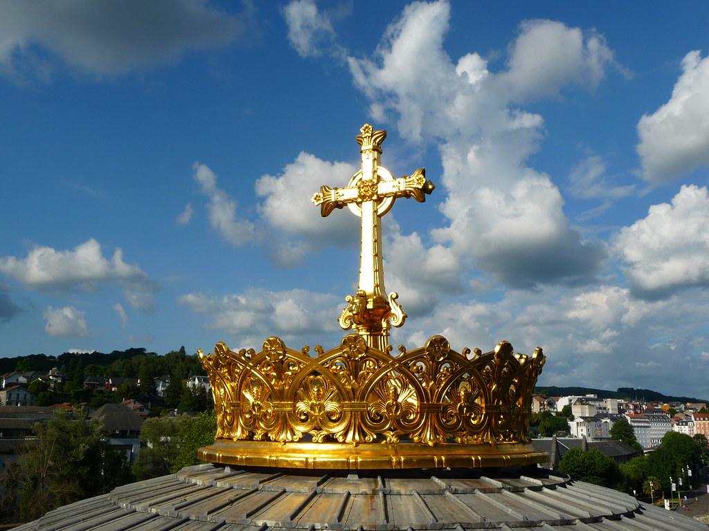 Golden crown and cross atop the Lourdes sanctuary during the Pope Leo Lourdes visit