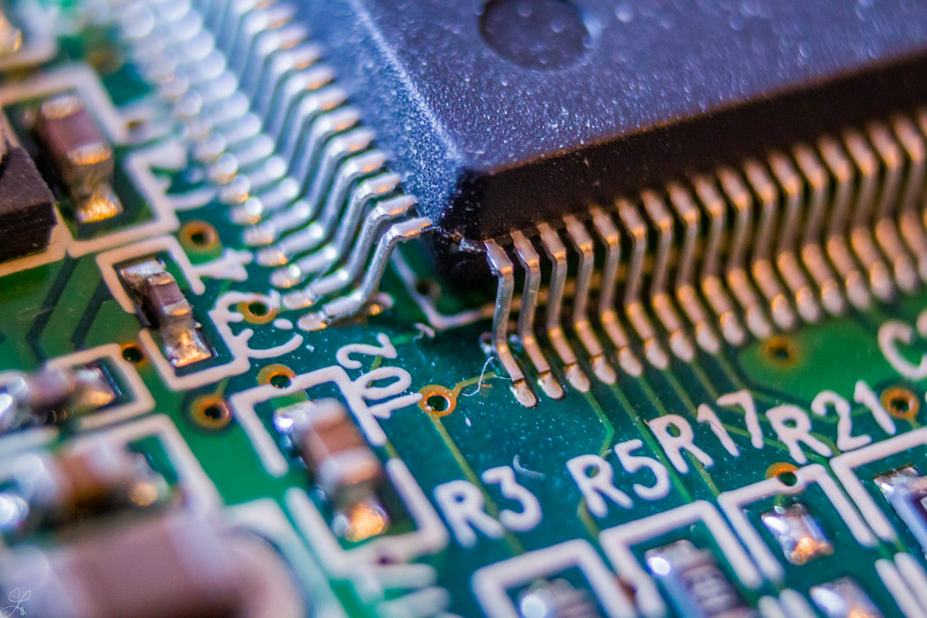 Close-up of a computer chip on a circuit board, illustrating the Positron AI funding round for inference silicon