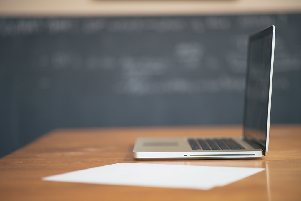 Laptop and paperwork representing applications affected by the DOL PERM suspension