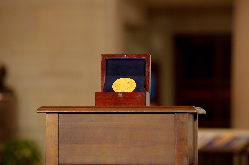 Gold medal in a presentation case representing the Nobel Prize economics 2026 awarded to Hall and Woodford