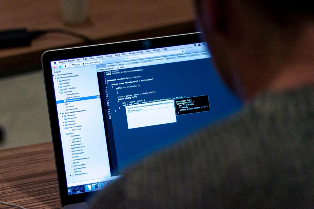 Software developer reviewing PHP code on a laptop after the PHP2Shell critical vulnerabilities disclosure