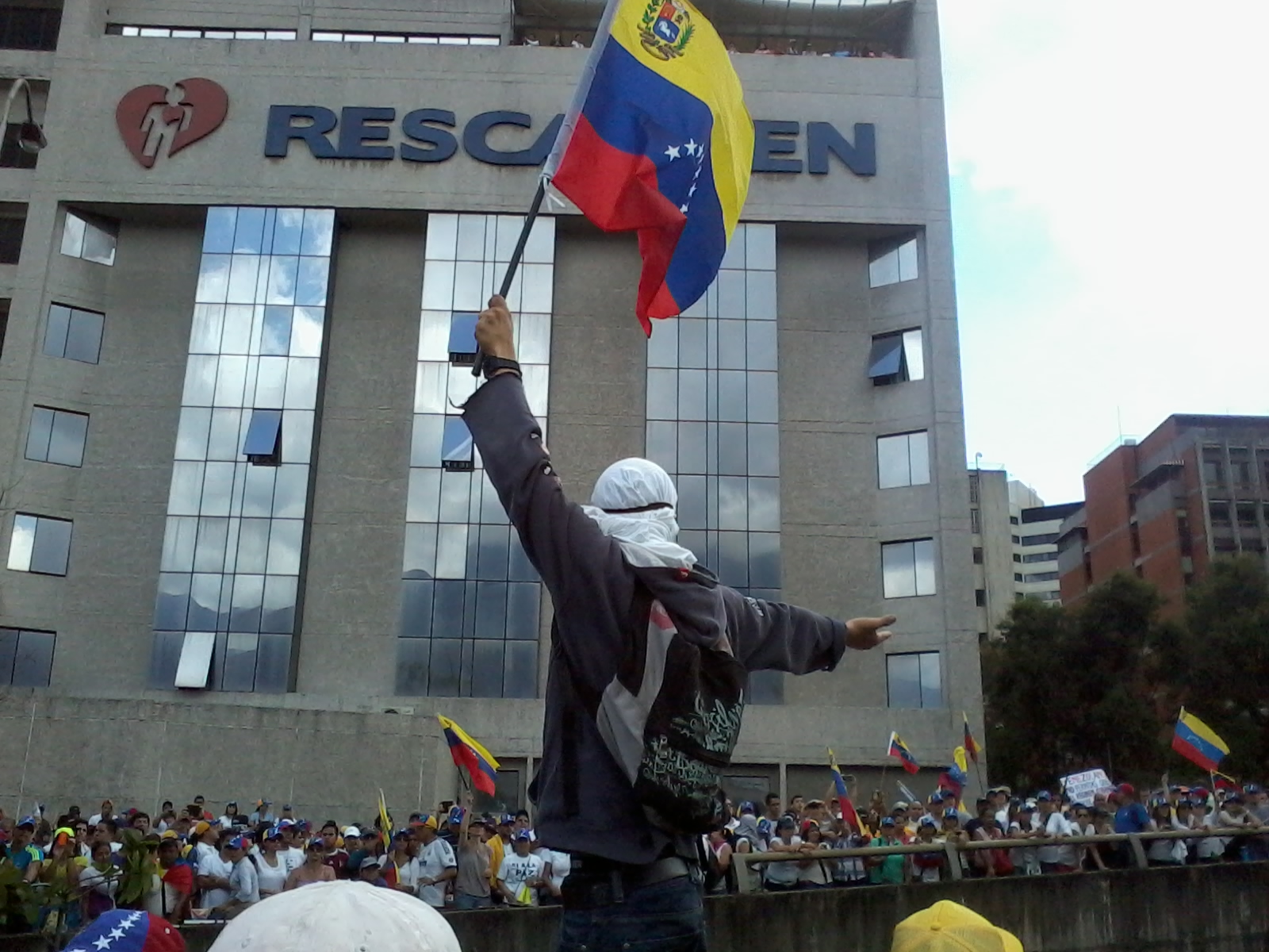 Venezuela election protests demonstrator waving the national flag in Caracas